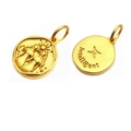 Detailed macro view of double-sided gold Gemini zodiac pendant with relief and engraving - Gemini