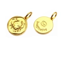 Macro detail of gold Cancer zodiac coin pendant with crab pattern and Imaginative text - Cancer
