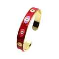 Detail of red enamel open bangle with colorful evil eye and hand of fatima charms - Red