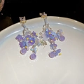 Close-up of delicate purple floral earrings with crystal studs and beaded tassel details. - Purple-Blue Resin Flower Style