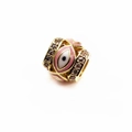 Macro view of 14K gold-plated evil eye charm bead with pink enamel and sparkling crystals - Pink Eye
