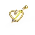 Detail view of golden heart-shaped arrow pendant with green enamel and zircon stones - Yellow