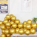 Bunch of shiny golden metallic 5-inch latex balloons in a golden iron basket decor - Gold