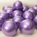 Round metallic purple latex balloons for party decoration on a soft white fur background - Purple