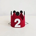 Detailed view of red felt birthday crown with white number 2 and black dot accents - Number 2