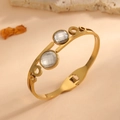 Gold stainless steel bangle with circular cutouts and clear round crystals - 3D Curve Round Style (F613) / Gold (White Rhinestone)