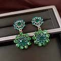Detailed view of vintage gold earrings with green and teal crystals in hollow circles. - Earrings Only (With Silver Earring Post) / Gold-Green
