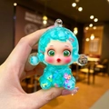 Close-up of translucent blue toy figurine with colorful floral patterns and green eyes - Large Luminous Bubble Bead Devil Girl / Green