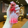 Close-up of pink glitter castle keychain with flowing sand and red metal lobster clasp - Lobster Clasp Style / Red