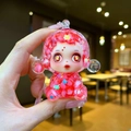 Detailed macro of a red transparent witch doll figurine with liquid sand and glitters - Large Luminous Bubble Bead Devil Girl / Red