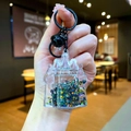 Detail of castle-shaped liquid keychain with colorful star sequins and a black bell - Lobster Clasp Style / Black