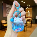 Detail of blue liquid quicksand lucky cat keychain with glitters and small bell charms - Colored Hardware Luminous Style / Blue