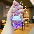Close-up of cute purple Lucky Cat liquid keychain with flowing sequins and a small bell - Colored Hardware Luminous Style / Purple
