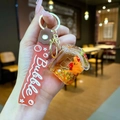 Detailed view of Capybara liquid quicksand keychain with star sequins and silicone strap - Small House Style (Strawberry Doll)
