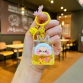 Detail of cartoon character keychain with liquid filling and shiny glitter sequins - Yellow Night Light Flashing Quicksand