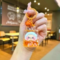 Detail of orange cartoon sheep liquid sand keychain with cherry blossom sequins and bell - Orange Night Light Flashing Quicksand