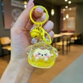 Dettaglio del portachiavi animale con sabbie mobili gialle, fiorellino e bambola cartoon - Tuanzi Scintillante Luminoso / Giallo