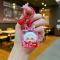 Close-up of RJ character liquid quicksand keychain with red glitter and bell detail - Red Night Light Flashing Quicksand
