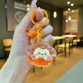 Dettaglio del ciondolo a sabbie mobili arancione con glitter e un piccolo criceto - Tuanzi Scintillante Luminoso / Arancione