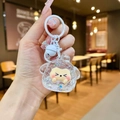 Detailed view of a cute cartoon dog keychain with glitter liquid and a small white bell - Lobster Clasp Style / Noctilucent Flash White Style