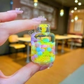 Macro detail of a luminous gas tank bottle pendant with macaron beads and snowflakes - Snowflake Gas Tank / Yellow Without Buckle