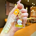 Detail of fortune cat keychain with floating gold glitter and green dollar signs in case - Gradient Strap Happy Cat Cube