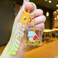 Close-up of Maneki Neko keychain featuring a yellow silicone strap and lucky cat charm - Gradient Strap Good Luck Cat Cube