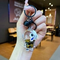 Detail of liquid sand keychain featuring a floating astronaut and golden star glitters - Lobster Clasp Style / Black Hardware [Guitar] Black Gold Astronaut