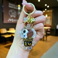 Astronaut liquid keychain with floating stars and purple bow on a golden keyring - Lobster Clasp Style / Gold Hardware [Guitar] Black Gold Astronaut