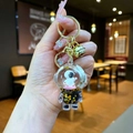 Astronaut keychain with floating liquid sequins and gold bell in a clear capsule - Lobster Clasp Style / Gold Hardware [Skateboard] Black Gold Astronaut