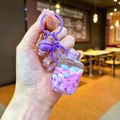 Détail d'un porte-clés violet créatif avec bouteille miniature remplie de sable liquide - Réservoir de gaz flocon de neige / Violet Avec Boucle