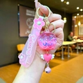 Detailed close-up of pink Sakura theme keychain featuring sequins and glitter star charms - Sakura Strap Pink Luminous Bubble Bead Bell