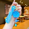 Close-up of blue Sakura themed keychain with liquid glitter ball and whale charm - Sakura Strap Blue Luminous Bubble Bead Bell