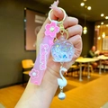 Close-up of pink Sakura keychain featuring a white swan charm and glittery liquid ball - Sakura Rope Series - White