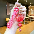 Detail of Sakura keychain with pink silicone strap and red glitter filled liquid ball - Sakura Strap Red Luminous Bubble Bead Bell