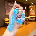 Detail of Sakura themed key chain with blue silicone strap and filled liquid bottle - Sakura Strap Blue Snow Gas Tank