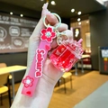 Macro detail of Sakura themed acrylic keychain with pink silicone strap and liquid charms - Sakura Strap Red Luminous Dried Flower Iceberg Cup