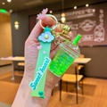 Close-up of green bubble tea cup keychain with liquid glitter and silicone strap - Green Luminous Frappe Cup