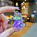 Dettaglio di un portachiavi a unicorno con liquido viola e glitter a forma di stella - Senza Portachiavi / Viola