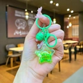 Neon green star-shaped liquid glitter keychain with bell and bow on a metal ring - Mini Style / Lobster Clasp / Green