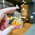 Detail of a mini unicorn keychain with orange liquid sand and star-shaped sequins - No Keychain / Orange