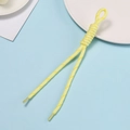 Close-up of yellow braided lanyard with decorative knot and clear plastic heat-shrink tips - Yellow With White/Yellow Dots
