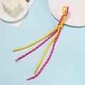 Detailed close-up of yellow and pink braided cord pendant on a light blue background - Rose Red And Yellow Block