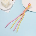 Macro detail of multicolored polyester braided cords with transparent heat-shrink end caps - Yellow And Pink Block