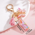 Dettaglio del ciondolo in resina con paillettes a cuore rosa e nappa a farfalla con misure - Rosa I