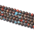 Detailed close-up of polished 6mm multi-color gemstone beads for DIY jewelry making - 1 Strand approx. 57 Pcs (6-6.5mm) / Blue Mottled