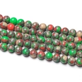 Macro detail of colorful marbled stone beads with vibrant green and red textured patterns - 1 Strand approx. 57 Pcs (6-6.5mm) / Green Mottled