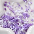 Assorted lavender and purple acrylic DIY beads in floral and bow shapes on a star tray - Purple Series
