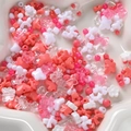 Macro view of assorted pink and white acrylic beads for DIY jewelry making in a star tray - Watermelon Red Series
