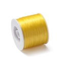 Detailed view of yellow 0.8mm flat elastic crystal string on a white plastic spool - Approx. 0.8mm Thickness / 400m Length / Pale Yellow
